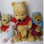 Six Winnie the Pooh Disney cuddly toys.