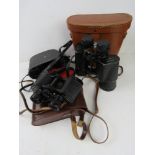 Three pairs of Binoculars, all in cases,
