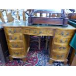 A 20th C. MAHOGANY PEDESTAL DESK WITH GREEN LEATHER INSET TOP OVER BOWED DRAWERS, THE CENTRAL