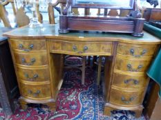 A 20th C. MAHOGANY PEDESTAL DESK WITH GREEN LEATHER INSET TOP OVER BOWED DRAWERS, THE CENTRAL