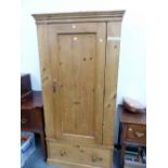 A VICTORIAN PINE WARDROBE WITH A DRAWER ABOVE THE PLINTH FOOT. W 85.5 x D 51 x H 188cms.