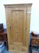 A VICTORIAN PINE WARDROBE WITH A DRAWER ABOVE THE PLINTH FOOT. W 85.5 x D 51 x H 188cms.