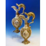 A PAIR OF FISCHER OF BUDAPEST RETICULATED BALUSTER EWERS WITH DRAGON HANDLES. H 44cms.