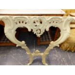 A GREEN VARIEGATED MARBLE TOPPED CREAM PAINTED ANTIQUE CONSOLE TABLE PIERCED AND CARVED IN THE
