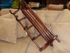 A BENT WOOD HAT AND COAT RACK WITH FIVE COAT HOOKS BELOW A FIVE BAR SHELF. W 91cms.