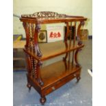 A 19th C. WALNUT THREE TIER BUFFET WITH A DRAWER BELOW THE LOWEST TIER ABOVE SPINDLE LEGS ON CASTER