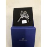 A SWAROVSKI OWL GROUP ON BRANCH WITH ORIGINAL BOX.