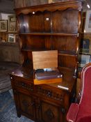 A MODERN OAK DRESSER, THE ENCLOSED BACK WITH TWO SHELVES, THE BASE WITH TWO FLUTED FRONTED DRAWERS