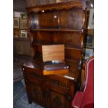 A MODERN OAK DRESSER, THE ENCLOSED BACK WITH TWO SHELVES, THE BASE WITH TWO FLUTED FRONTED DRAWERS