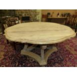 A BLEACHED OKA, "TUDOR ROSE" TABLE, THE SHAPED CIRCULAR TOP ON FOUR BRACKET LEGS JOINED BY A STRET