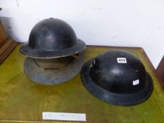 THREE VINTAGE MILITARY TIN HATS.