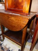 A 20th C. OAK FLAP TOP TWO TIER TROLLEY. W 61 x H 72cms.