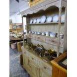 A MODERN BLEACHED PINE DRESSER WITH THREE DRAWERS CENTRAL TO THE ENCLOSED BACK, THREE FURTHER