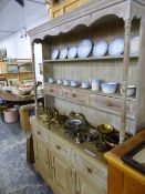 A MODERN BLEACHED PINE DRESSER WITH THREE DRAWERS CENTRAL TO THE ENCLOSED BACK, THREE FURTHER