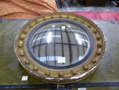 A CONVEX MIRROR WITHIN A BEADED GILT FRAME.   Dia. 41cms.