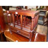 A REGENCY MAHOGANY FOUR COMPARTMENT CANTERBURY WITH A DRAWER ABOVE THE CASTER FEET.