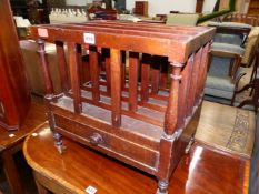 A REGENCY MAHOGANY FOUR COMPARTMENT CANTERBURY WITH A DRAWER ABOVE THE CASTER FEET.