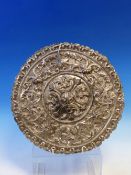 AN EMBOSSED WHITE METAL ROUNDEL, POSSIBLY PART OF A LATIN AMERICAN RELIQUARY, WITH STIPPLE