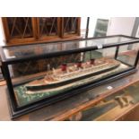A SCALE MODEL OF THE PASSENGER SHIP THE QUEEN MARY IN A GLAZED EBONISED CASE W 96.5cms.