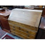 AN OAK BUREAU, THE FALL OVER TWO SORT AND TWO GRADED LONG DRAWERS AND BRACKET FEET. W 92 x