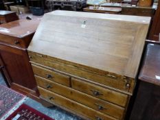 AN OAK BUREAU, THE FALL OVER TWO SORT AND TWO GRADED LONG DRAWERS AND BRACKET FEET. W 92 x