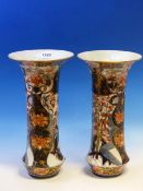 A PAIR OF IMARI STYLE WAISTED CYLINDRICAL VASES PAINTED WITH GARDEN PANELS, PINE AND FLOWERING