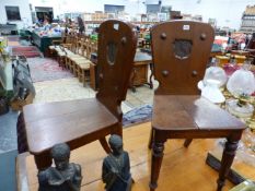 A PAIR OF 19th C. OAK HALL CHAIRS, THE SOLID BACKS WITH RECESSED SHIELDS PAINTED WITH FALCON CRESTS,