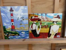 TWO DECORATIVE PORCELAIN PLAQUES, ONE WITH A COASTAL LIGHT HOUSE THE OTHER OF A HORSE RACE. 28 x