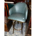 A GREEN LEATHER DESK CHAIR ROTATING AND ADJUSTABLE ON FOUR GILT TUBULAR METAL LEGS JOINED BY A