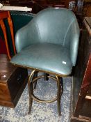 A GREEN LEATHER DESK CHAIR ROTATING AND ADJUSTABLE ON FOUR GILT TUBULAR METAL LEGS JOINED BY A