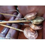 FOUR ANTIQUE COPPER AND BRASS WARMING PANS, A DRIVING WHIP, AND A LONG HANDLES GAFF.