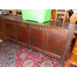 AN 18th C. OAK COFFER WITH A CARVED BAND OF ARCHES ABOVE THE FOUR PANELLED FRONT. W 157 x D 57 x H