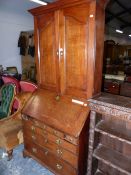 A GEORGE III OAK BUREAU BOOKCASE, THE CAVETTO CORNICE OVER PANELLED DOORS, BURR WOOD BANDED FALL,