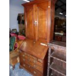 A GEORGE III OAK BUREAU BOOKCASE, THE CAVETTO CORNICE OVER PANELLED DOORS, BURR WOOD BANDED FALL,