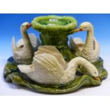 A BRETBY POTTERY TABLE CENTRE PIECE MODELLED AS THREE SWAN FORM BOWLS SWIMMING ON A GREEN BASE ABOUT