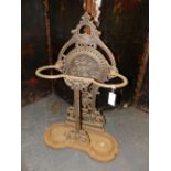 A VICTORIAN FALKIRK IRON STICK STAND CAST WITH A HANDLE ABOVE A FLORAL ROUNDEL AT THE TOP OF THE