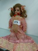 AN ANTIQUE BISQUE HEAD DOLL UNSIGNED.