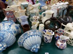 A COLLECTION OF ANTIQUE AND LATER WASH JUGS, EWERS, A WALL MOUNTED STOOP, ETC.