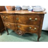 AN 18th C. PROVINCIAL FRENCH WALNUT COMMODE WITH TWO WAVY FRONTED DRAWERS BETWEEN CARVED FOLIAGE AND