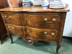 AN 18th C. PROVINCIAL FRENCH WALNUT COMMODE WITH TWO WAVY FRONTED DRAWERS BETWEEN CARVED FOLIAGE AND