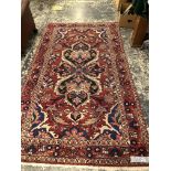 AN ANTIQUE PERSIAN SHIRAZ RUG. 180x125cms TOGETHER WITH ANOTHER PERSIAN RUG. 250x141 (2)