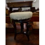 A 19th C. MAHOGANY PIANO STOOL,THE CIRCULAR SEAT ADJUSTABLE ON THREE GADROONED BALUSTER LEGS AND