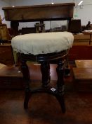 A 19th C. MAHOGANY PIANO STOOL,THE CIRCULAR SEAT ADJUSTABLE ON THREE GADROONED BALUSTER LEGS AND