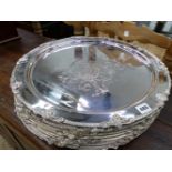 TEN LARGE SILVER PLATED ARMORIAL PLATTERS.