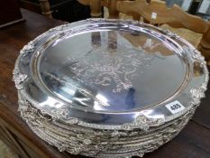 TEN LARGE SILVER PLATED ARMORIAL PLATTERS.