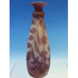 AN ACID ETCHED MAUVE CAMEO GLASS VASE WORKED WITH FLOWERS AND FOLIAGE. H 15cms.