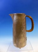 A LIBERTYS TUDRIC PEWTER JUG WITH ENTRELAC OVAL TO THE BODY BY THE CANED HANDLE. H 19.5cms.