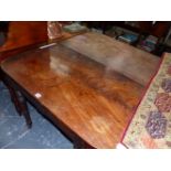 A REGENCY MAHOGANY DINING TABLE, THE TWO RECTANGULAR ENDS ROUNDED ABOVE THE APRON, THE TURNED
