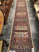 AN ORIENTAL RUNNER OF CAUCASIAN DESIGN. 341 x 72cms