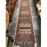 AN ORIENTAL RUNNER OF CAUCASIAN DESIGN. 341 x 72cms